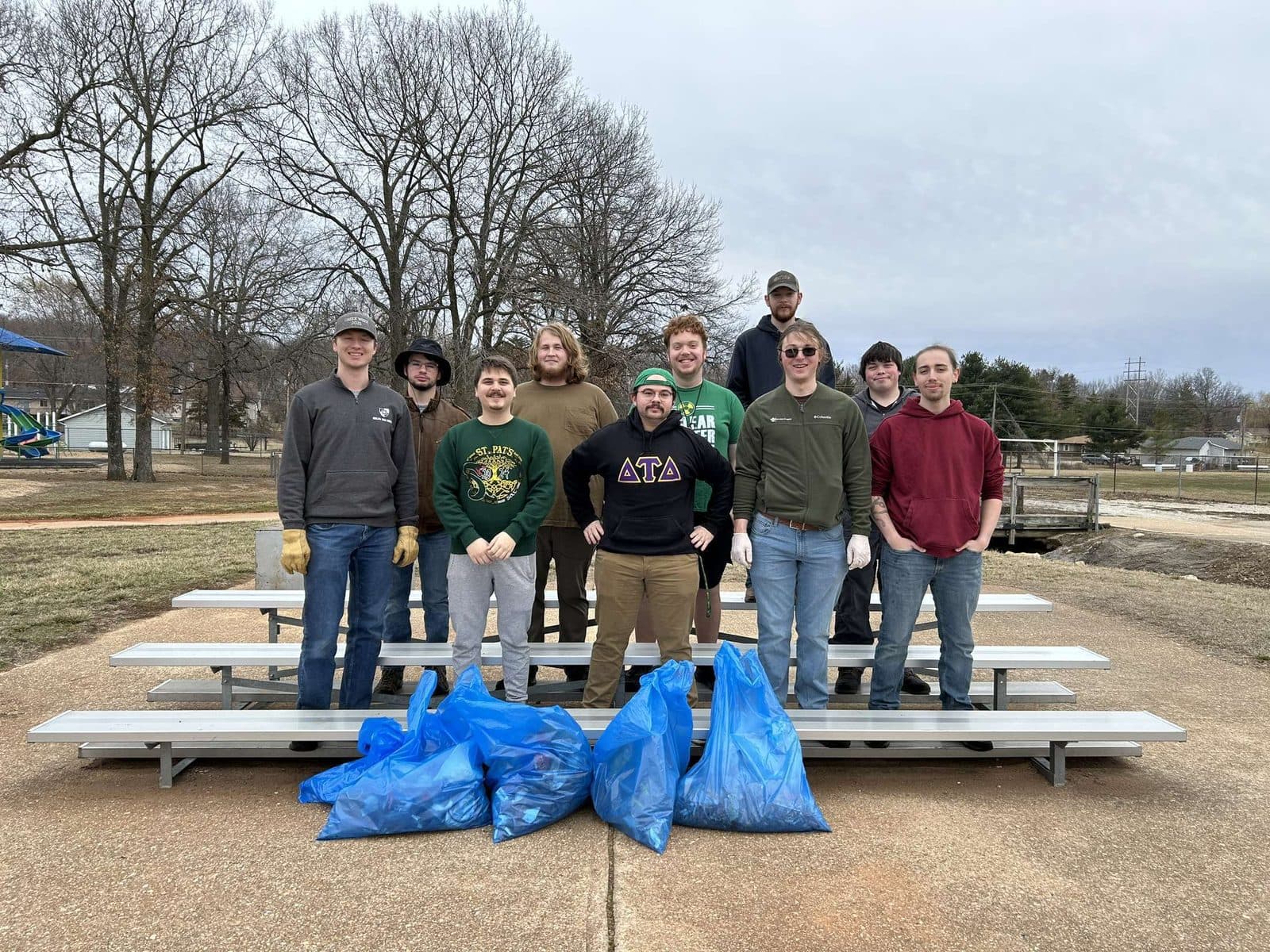 Brothers volunteering at a community park cleanup